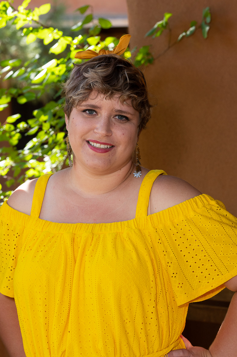 woman in yellow shirt and green foliage